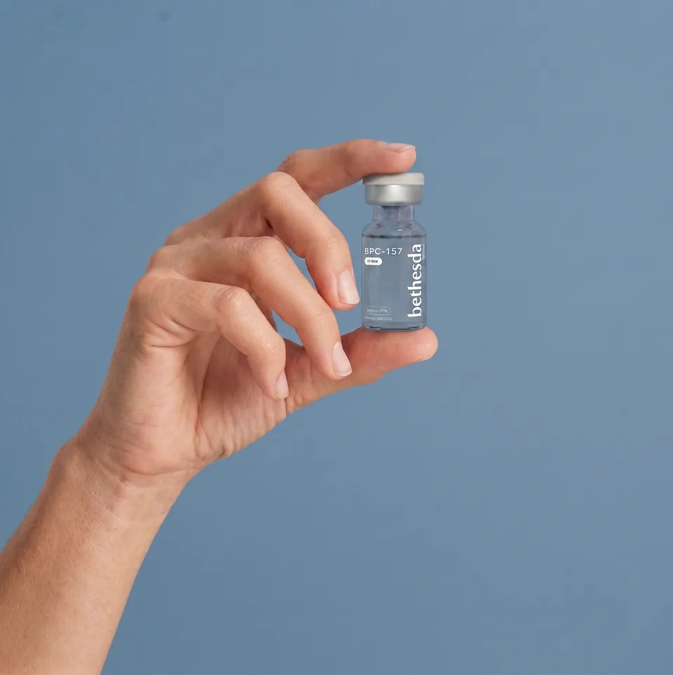 Bethesda BPC-157 research vial held in hand, research use only
